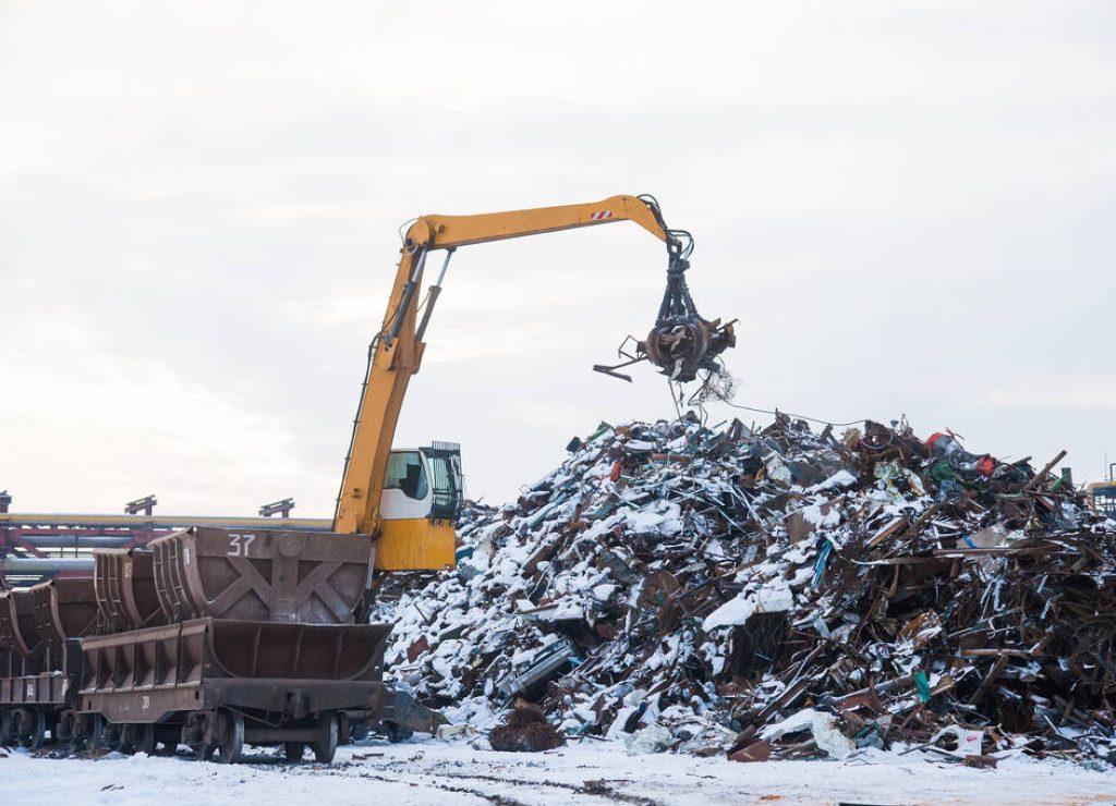 Scrap metal recycling plant and crane-loading scrap in a train